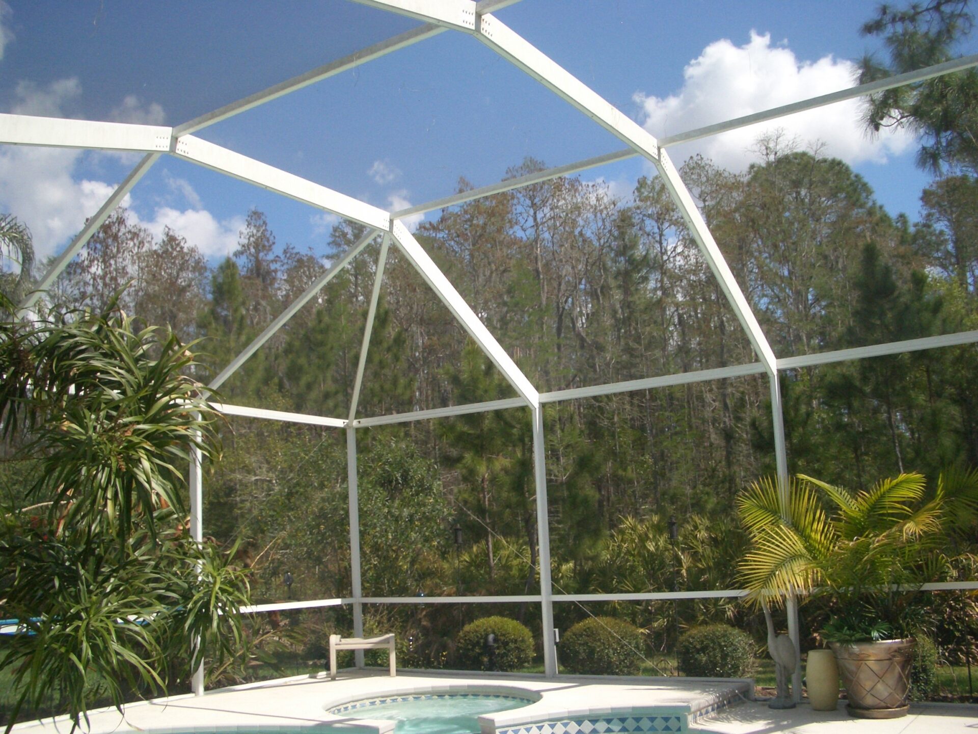 A pool with a large white roof and some trees